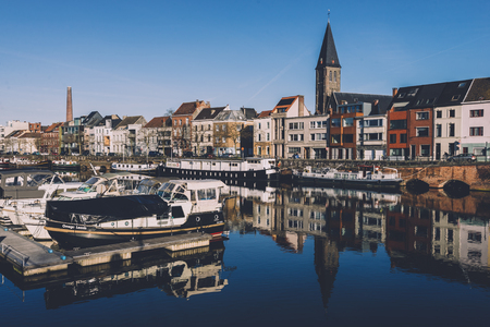December, 27th, 2016 - Ghent, East Flanders, Belgium. Portus Ganda marina with colorful belgian houses, private boats and barges in docks reflected on the water of canal in flemish city Gent.のeditorial素材