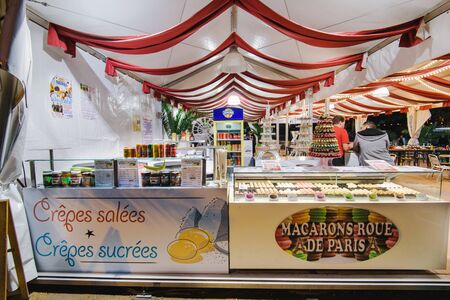 Paris, France - August 8, 2017. French crepes and macarons street cafe in amusement park. Paris bistro or restaurant summer terrace sailing macaroons, drinks and other traditional french sweets.のeditorial素材