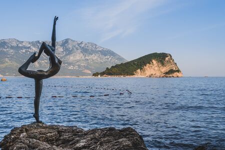 May, 30th, 2016 - Budva, Montenegro. Dancing Girl statue in Budva Old Town Citadele, Sveti Nikola island and Adriatic sea on background.のeditorial素材
