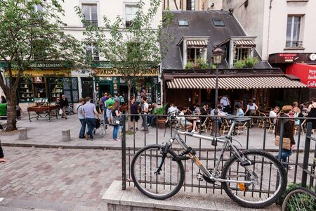 Paris, France - August 11, 2017. Famous Shakespeare and company bookstore and French restaurant view with bicycle in front. Popular touristic landmark. Bookshop and parisian cafe near Cite island.のeditorial素材