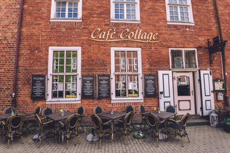 April, 18th, 2017 - Potsdam, Brandenburg, Germany. Street restaurant with outdoor tables, old brick...
