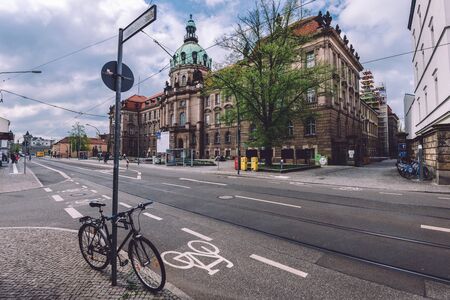 April, 18th, 2017 - Potsdam, Brandenburg, Germany. Potsdam Rathaus new town hall building and parked bike near bicycle track on crossroad.のeditorial素材