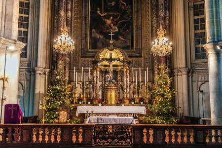 Vienna, Austria - December 24, 2017. Minoritenkirche christmas interior with xmas trees and candles in candelabras. Nationalkirche Maria Schnee or Church of Mary of the Snows decorated altar.のeditorial素材