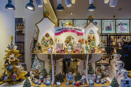 Vienna, Austria - December 29, 2017. Showcase with Christmas souvenirs and decor. Illuminated display with xmas glass balls, cups and christmas trees.のeditorial素材