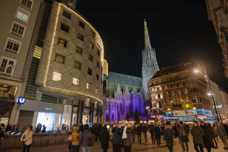 Vienna, Austria - December 24, 2017. Crowded Stephansplatz and illuminated St. Stephen's Cathedral in Christmas eve. Lot of people walking on central viennese square in evening.のeditorial素材