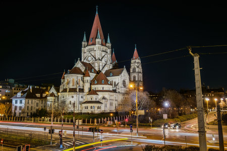 Vienna, Austria - December 29, 2017. St. Francis of Assisi Church, or Emperors Jubilee Church, or Mexico Church, is Basilica-style Catholic church. Night view of Art Nouveau landmark building.のeditorial素材