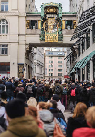 Vienna, Austria - December 30, 2017. Tourist crowd in front of famous Anker Clock chimes on Hoher Markt. Oldest square in Vienna and people waiting for afternoon show with figures and music.のeditorial素材