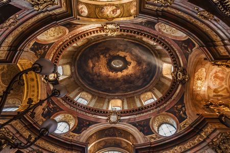 Vienna, Austria - December 31, 2017. Ceiling paintings and sunbeam in St. Peter Church. View of Peterskirche dome with sun ray, pictures and fresco depicts Holy Spirit as pigeon.のeditorial素材