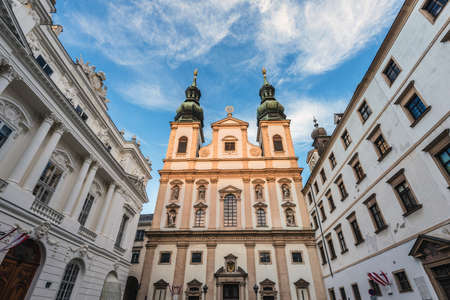 Vienna, Austria - December 31, 2017. View of Jesuit Church double tower. Viennese University church facade in golden evening light.のeditorial素材
