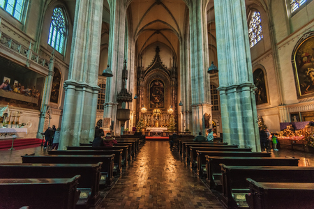 Vienna, Austria - December 24, 2017. Inner view of Minoritenkirche or Church of Mary of the Snows built in gothic architecture style. Medieval Maria Schnee church interior with Christmas decoration.のeditorial素材