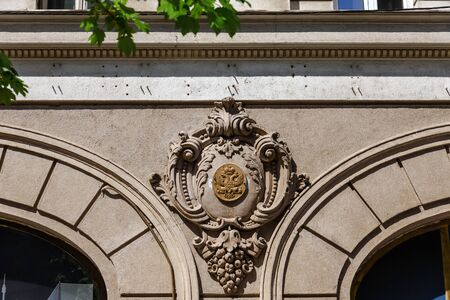 Belgrade, Serbia - April 19, 2018. Architecture building in old town central street with decorative details and serbian national coat of arms on golden tablet, close view.のeditorial素材