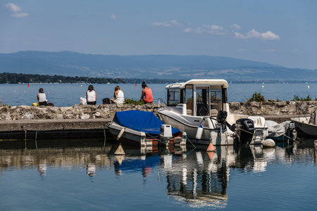 People Sitting at Embankment of Geneva Lake