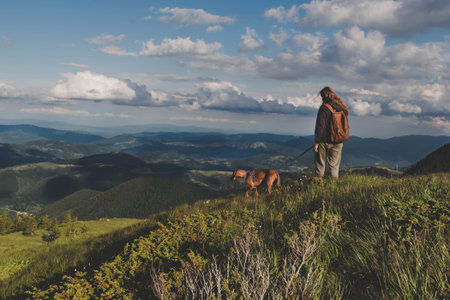 Hiker Girl with Dog on Hiking Trail in Mountain
