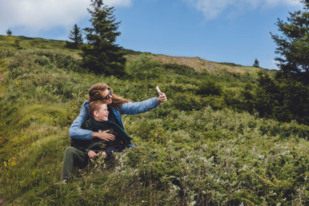 Mother with Son Taking Selfie in Mountain Landscape