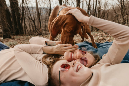 Family with Vizsla Dog Having Fun in Natureの写真素材