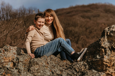 Mother and Child Having Fun on Forest Rockの写真素材