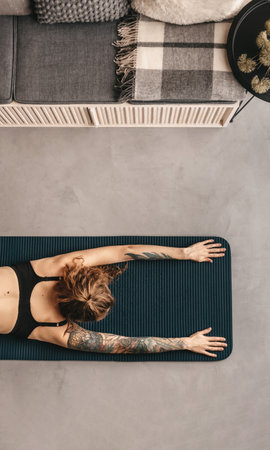 Woman Practicing Yoga and Doing Stretching Exercisesの写真素材