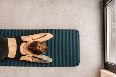 Woman Practicing Yoga in Puppy Pose Variationの写真素材