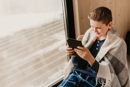 Teenager Boy in Pajama Reading at Homeの写真素材