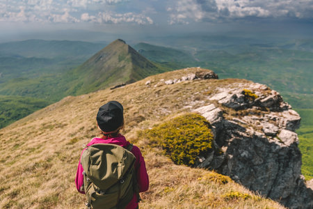 Woman Tourist with Backpack Travel in Mountainsの写真素材