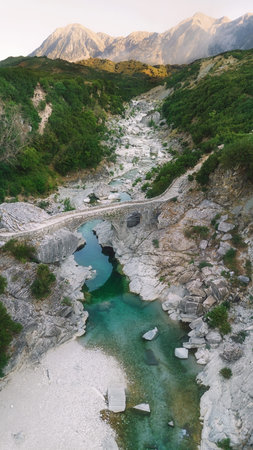 Aerial Drone View of Brataj Bridge amidst Mountains