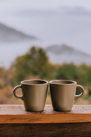 Cozy Autumn Morning with Two Coffee Cupsの写真素材