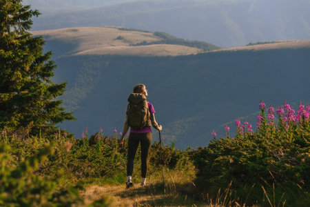 Woman with Tourist Backpack Hiking in Mountains