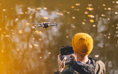 Man Using Remote Control to Fly Droneの写真素材