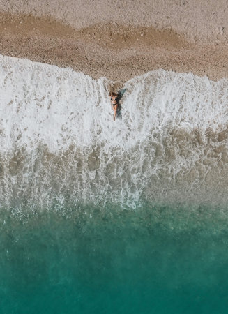 Drone View of Woman Relaxing on Beach