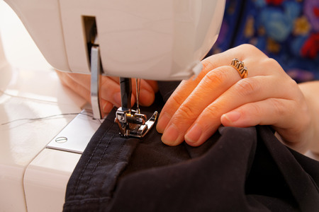 Hands seamstress at the sewing machine の写真素材