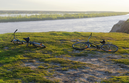 Two bicycles lying on a steep bankの写真素材