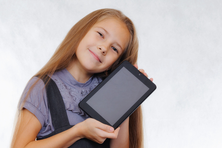 A teenager girl enjoys a new tabletの写真素材