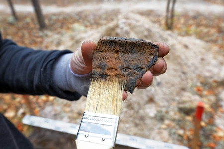 Archaeological discovery - a fragment of ancient ceramic vesselの写真素材