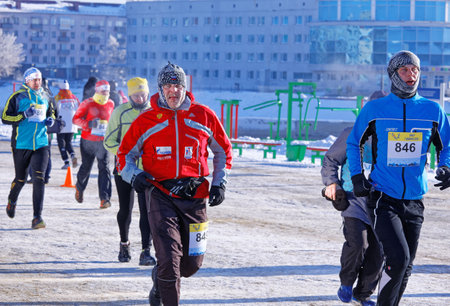 Editorial. Omsk,Russia - January, 07 2018. Leading runners during Urban Christmas winter half marathon in Naberezhnaya Tukhachevskogo streetのeditorial素材