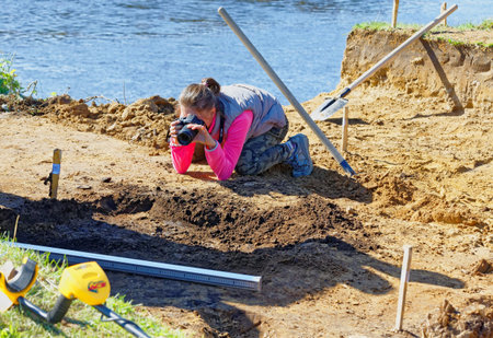 The girl photographer photographs archaeological finds and their location