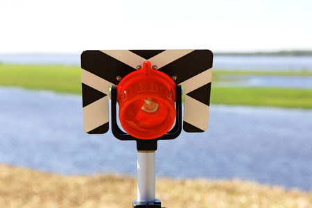 Milestone geodesic with a reflector installed on the river bankの写真素材