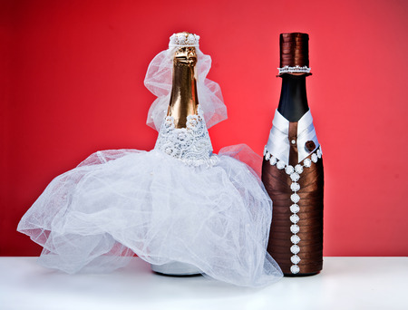 Souvenir bottles for a wedding on a red backgroundの写真素材