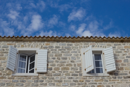 The windows on the facade of stone Houseの写真素材