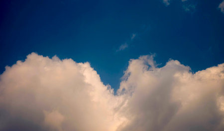 Sunny sky background in vintage retro style. The sun are shining from saturated clouds. In the red blue sky cloud and sunrise orange color.の写真素材