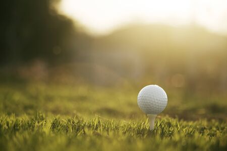 golf ball on tee in a beautiful golf course with morning sunshine.Ready for golf in the first short.Sports that people around the world play during the holidays for health.の写真素材