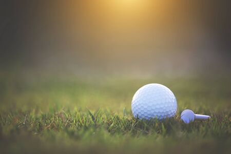 Golf ball is on a green lawn in a beautiful golf course with morning sunshine.Ready for golf in the first short.Sports that people around the world play during the holidays for health.の写真素材