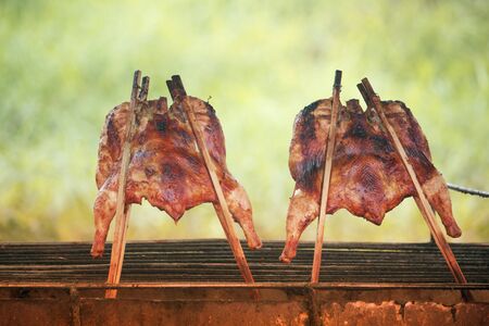 Grilled chicken on the stove is cooked, colorful, appetizing.Popular food of Thai people who often eat with papaya saladの写真素材