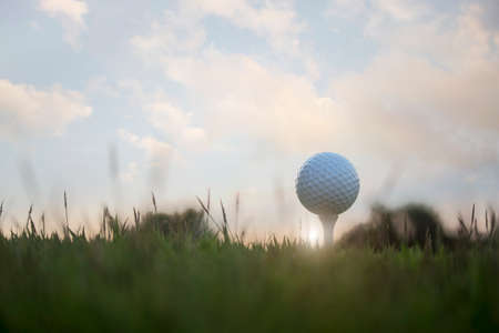 golf ball on tee in a beautiful golf course with morning sunshine.Ready for golf in the first short.Sports that people around the world play during the holidays for health.の写真素材