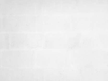 White concrete wall background in vintage style for graphic design or wallpaper. Pattern of soft cement floor in retro concept. Gray abstract texture detail in construction.の写真素材