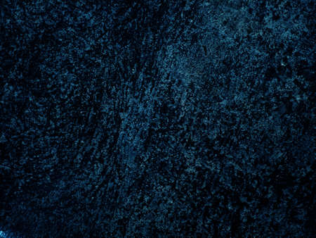 Dark rough cement wall background for graphic design or wallpaper. Grungy black and blue concrete texture in vintage style. The old plaster floor has a mysterious and terrifying age.の写真素材