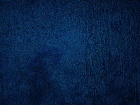 Dark rough cement wall background for graphic design or wallpaper. Grungy black and blue concrete...