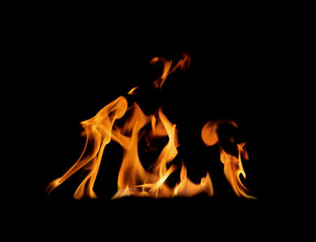 Flames isolated on black background for graphic design or wallpaper. Close up red and yellow, heat...