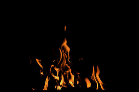 Close up burning flames on black background for graphic design or wallpaper. Red and yellow, heat...