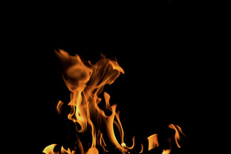 Close up burning flames on black background for graphic design or wallpaper. Red and yellow, heat...