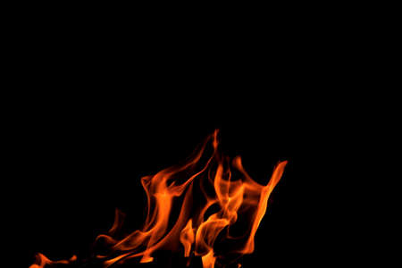 Close up burning flames on black background for graphic design or wallpaper. Red and yellow, heat...